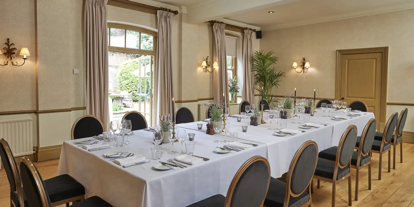 A dining room featuring a spacious table and chairs.