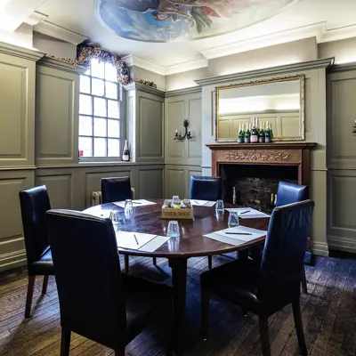 A meeting room featuring a table and chairs