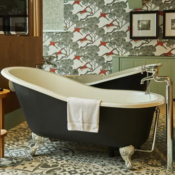 2 bathtubs side by side with a TV face both of them