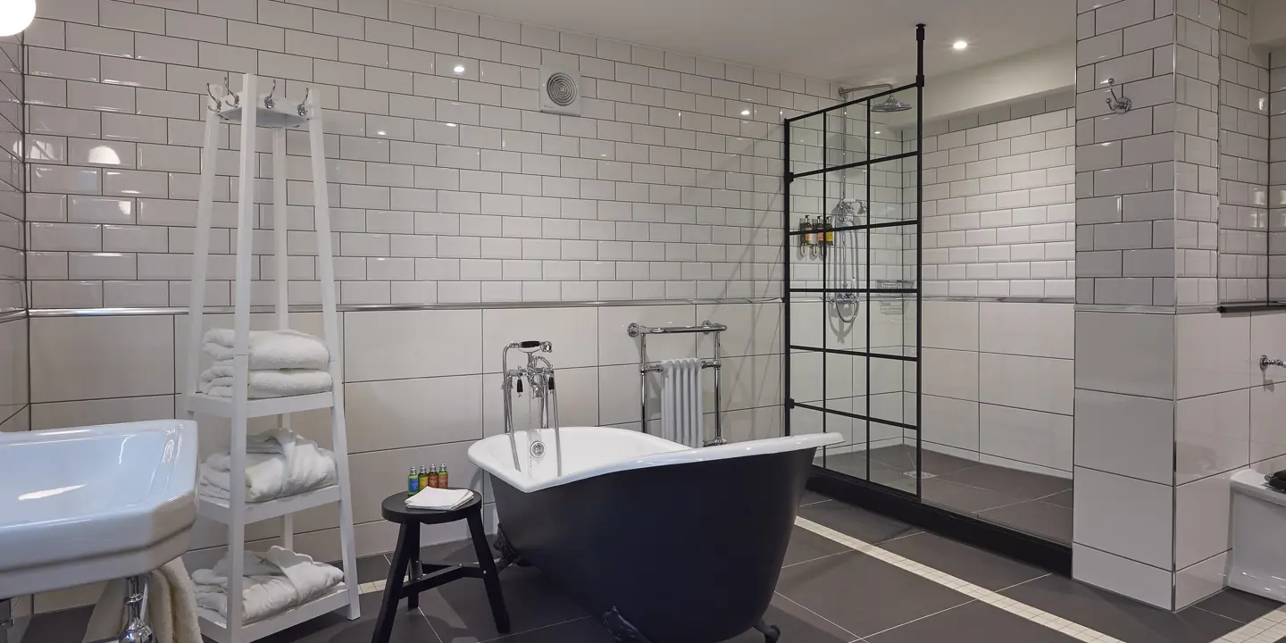 Black bathtub and white sink in a bathroom.