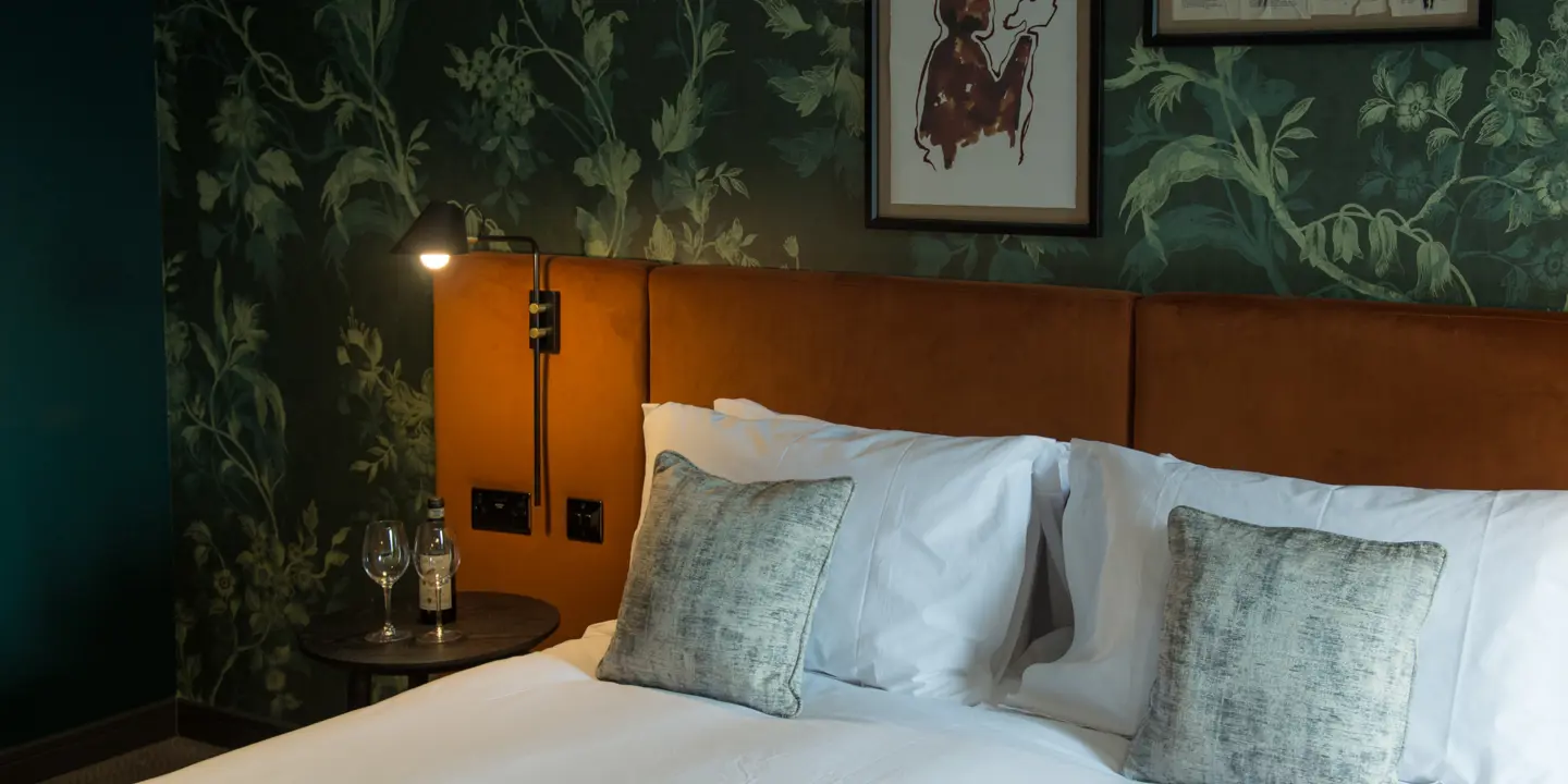 Bed with two pillows and nightstand.