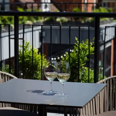 Two wine glasses placed on a table outside.