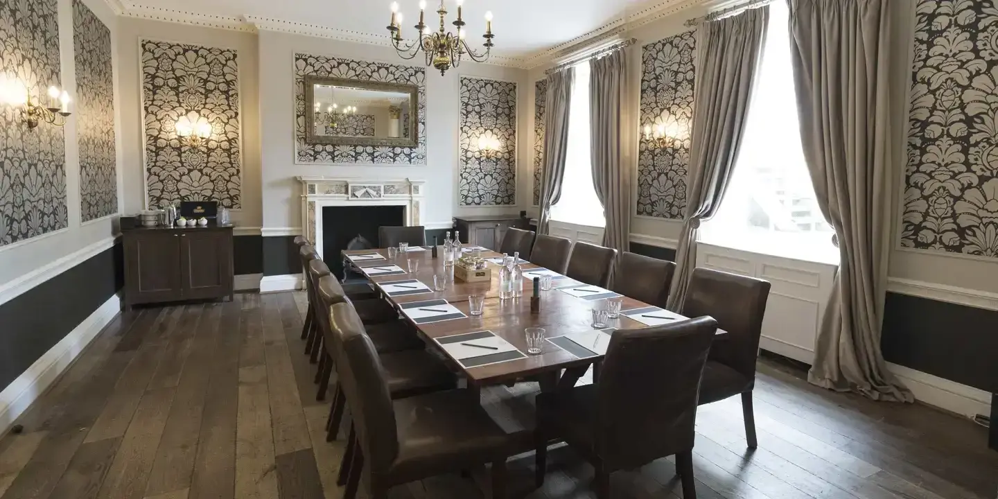 A Meeting room with long table and chandelier