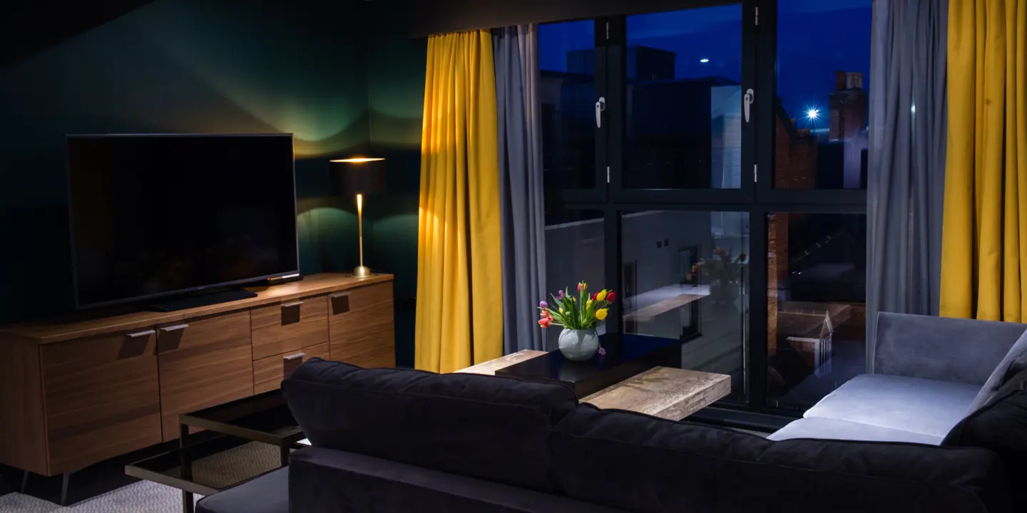 A well-furnished living room featuring a flat-screen TV.