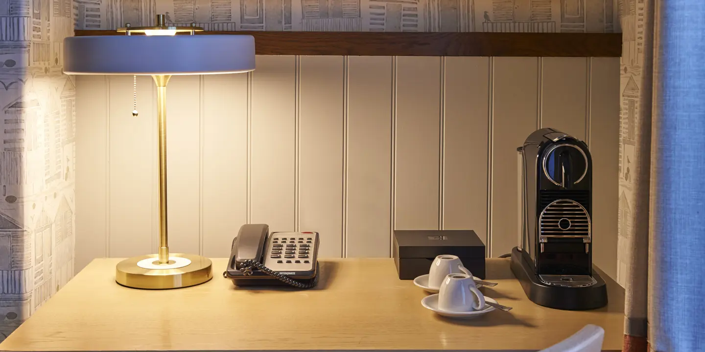 Desk featuring a lamp and telephone.
