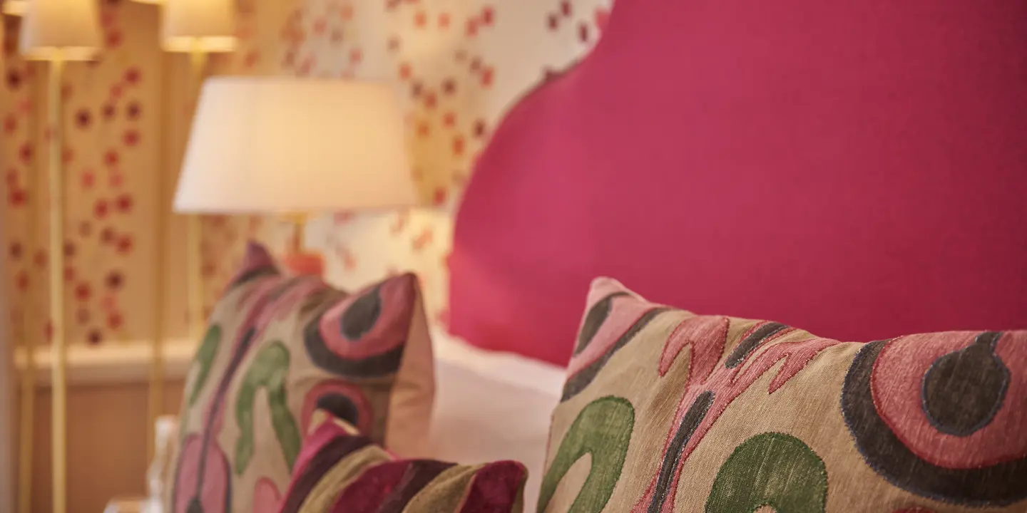 Close-up view of a neatly made bed adorned with pillows.