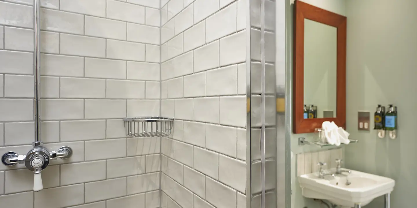 A bathroom featuring a sink, mirror, and towel rack.