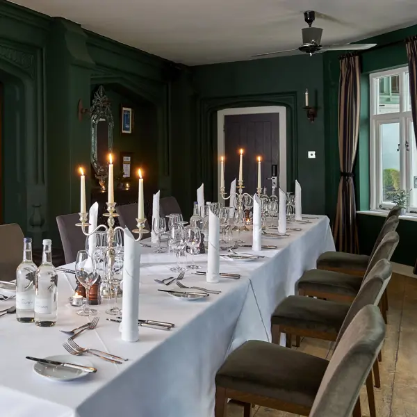 A dining room featuring a spacious table and chairs.