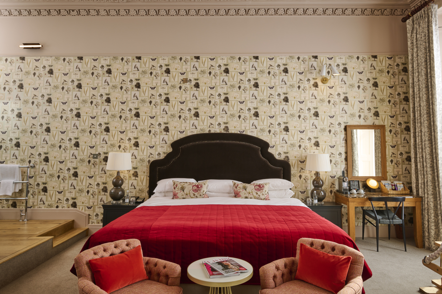 A room containing a double bed, 2 chairs, a table