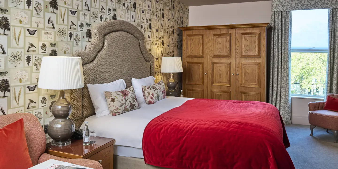 A neat and organised suite, with a large double bed in the centre