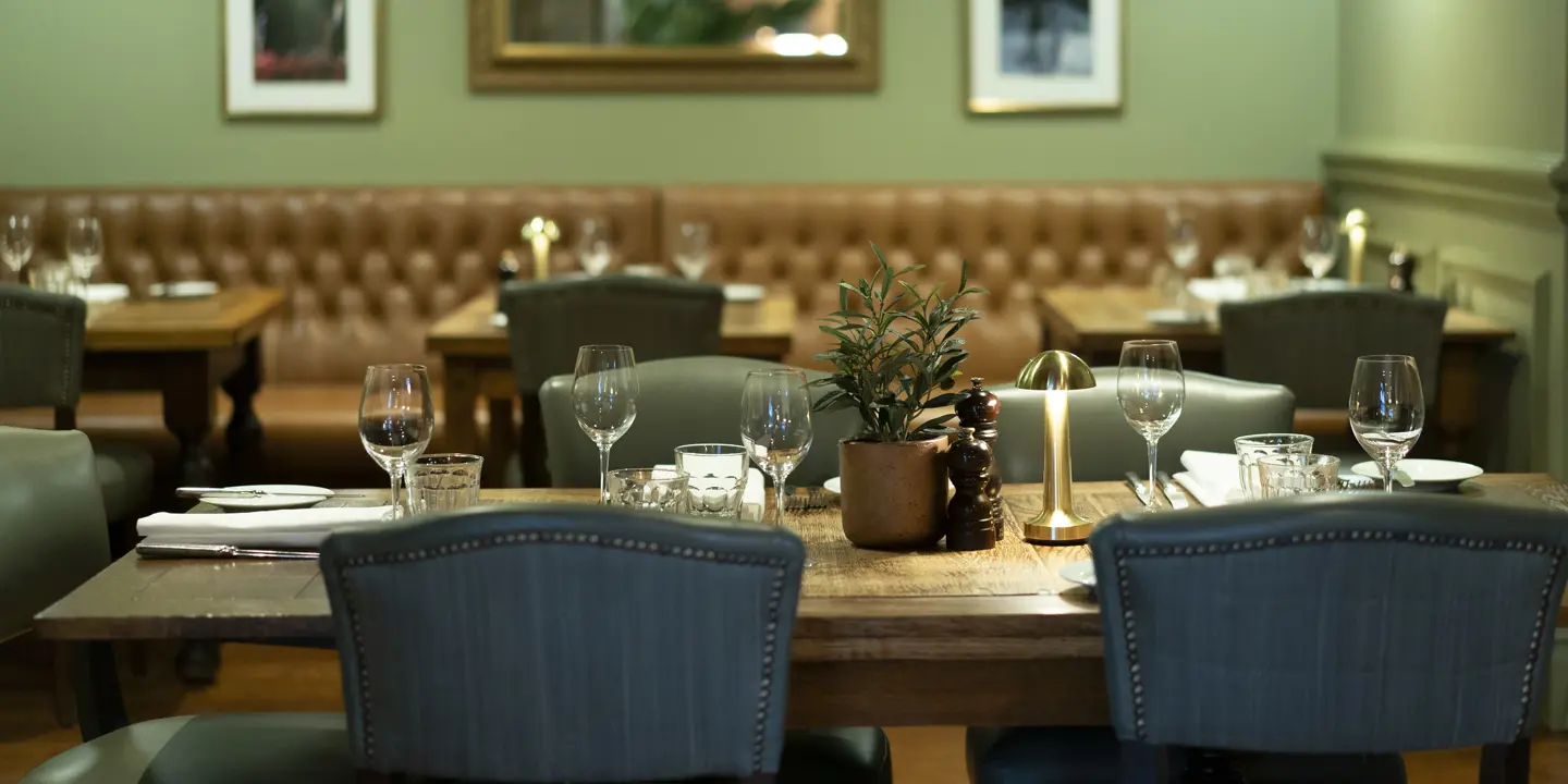 A dining room featuring a wooden table and chairs.