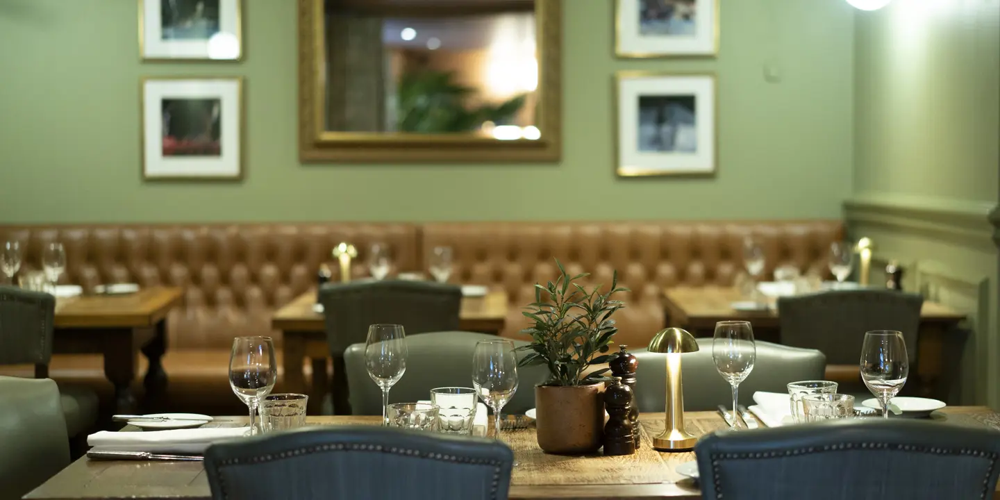 A dining room featuring a wooden table and chairs.