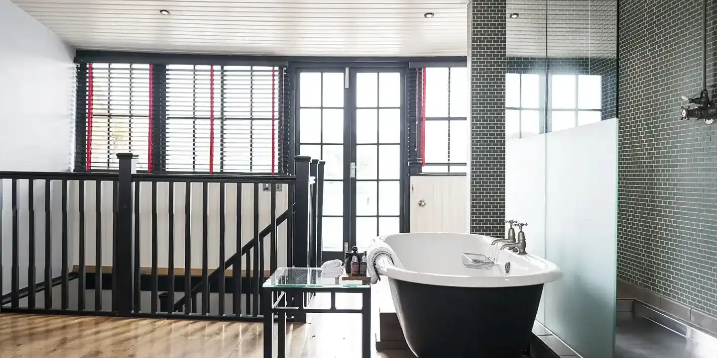 Bathroom featuring a bathtub and window.