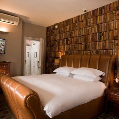 Spacious bedroom featuring a king-sized bed and television.