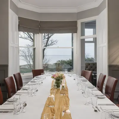 Table set for a formal dinner with candles.