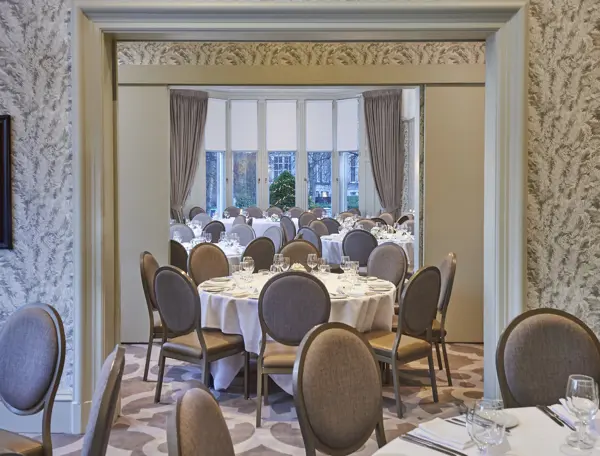 Spacious room with multiple, sophisticated decorated round tables