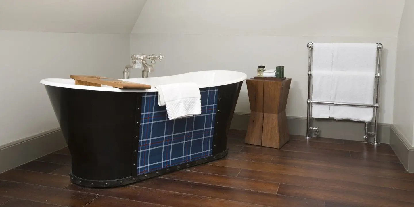 A bathroom with a large bath and sink