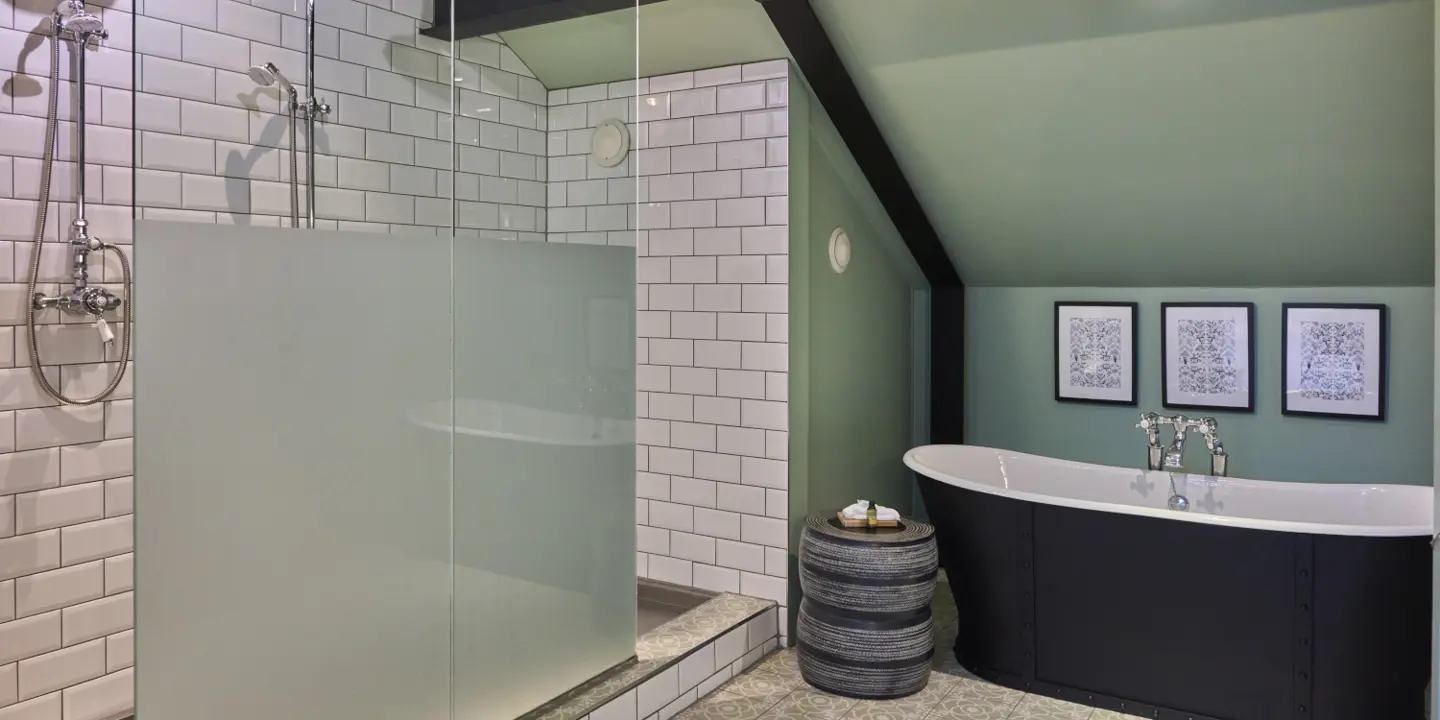 elegant bathroom with shower and separate roll top bath