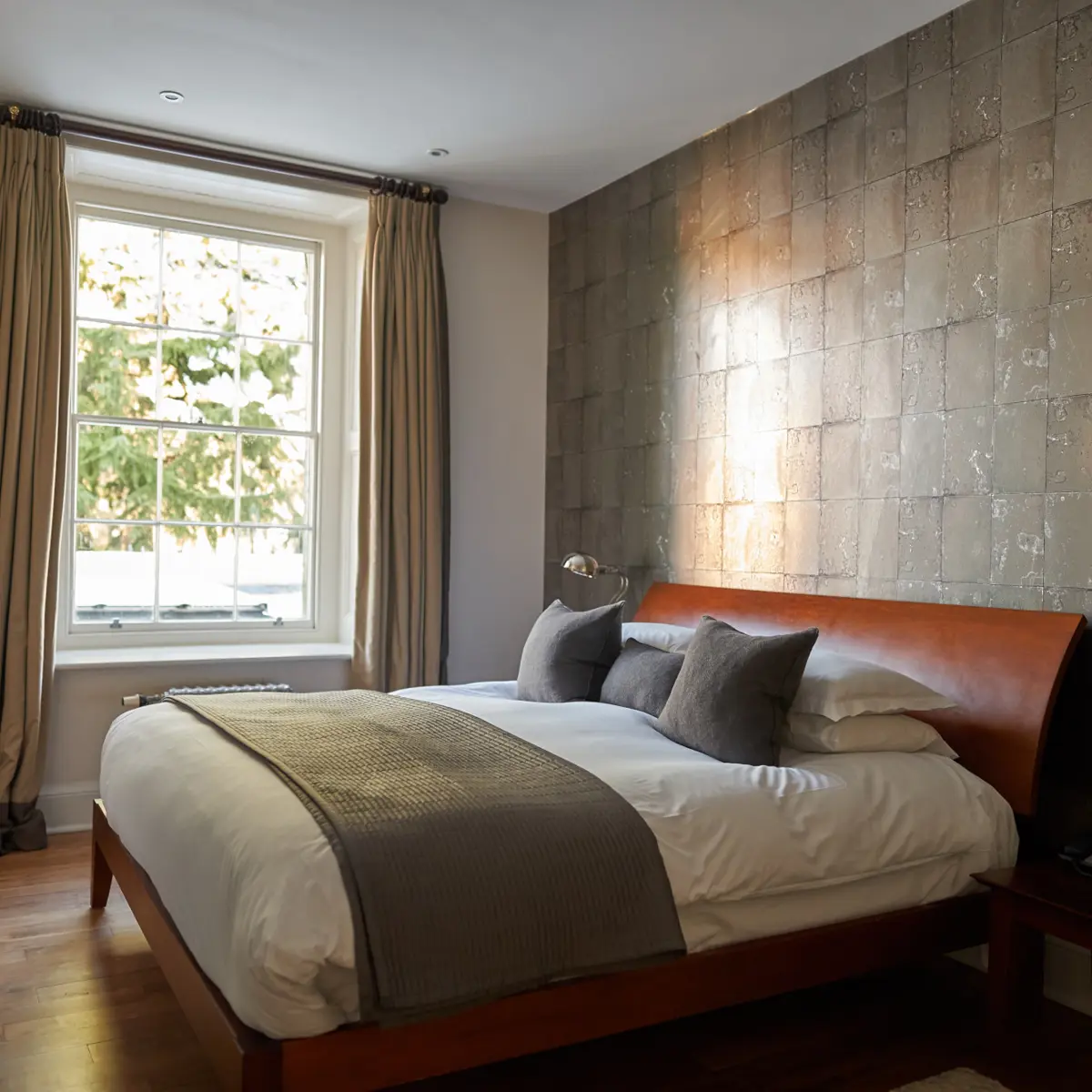 Bedroom featuring a comfortable bed and a window.