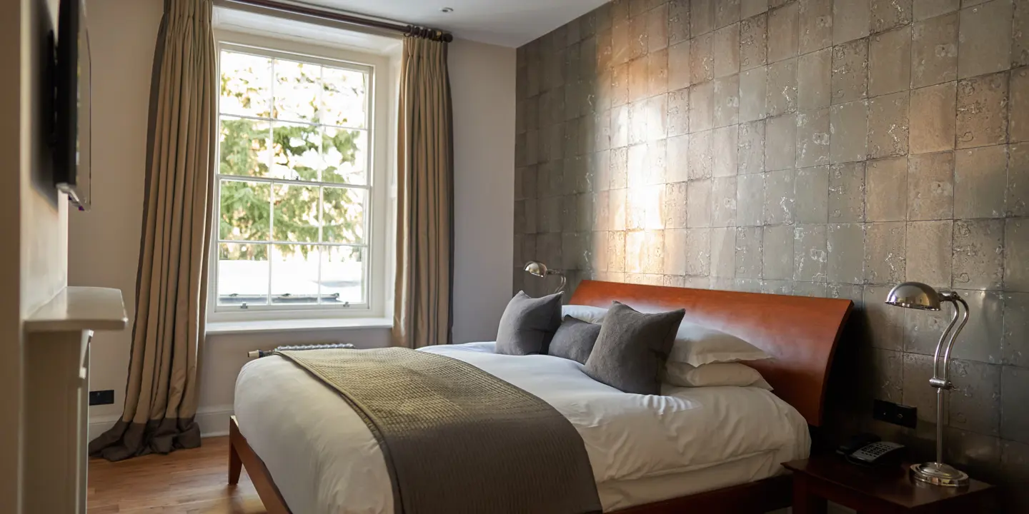 Bedroom featuring a comfortable bed and a window.