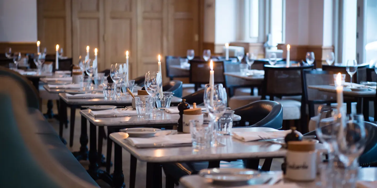 A beautifully arranged table adorned with elegant place settings and flickering candles.