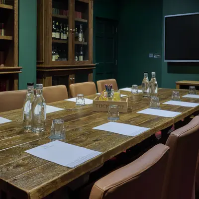 Wooden table with glasses and bottles.