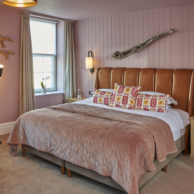 Bedroom featuring a comfortable bed and chair.
