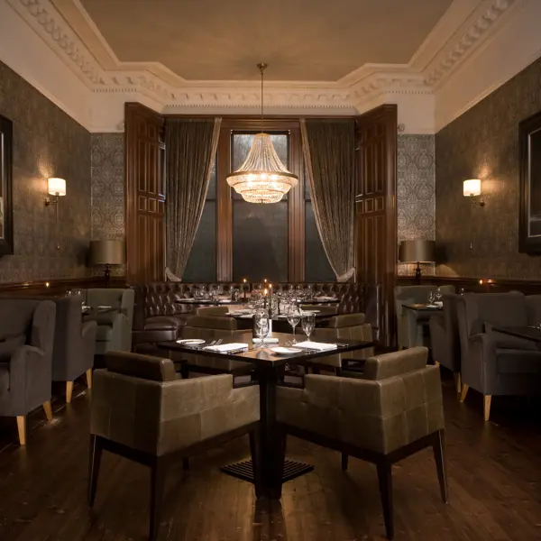 Dining room featuring elegant chairs and a stunning chandelier.