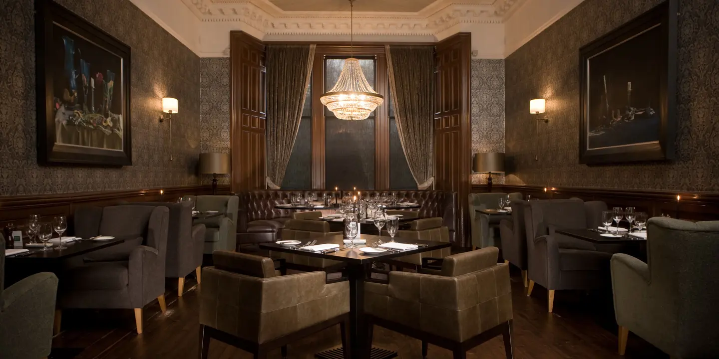 Dining room featuring elegant chairs and a stunning chandelier.