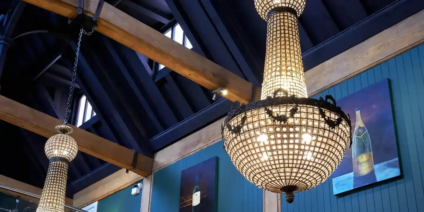 Chandelier suspended from restaurant ceiling.