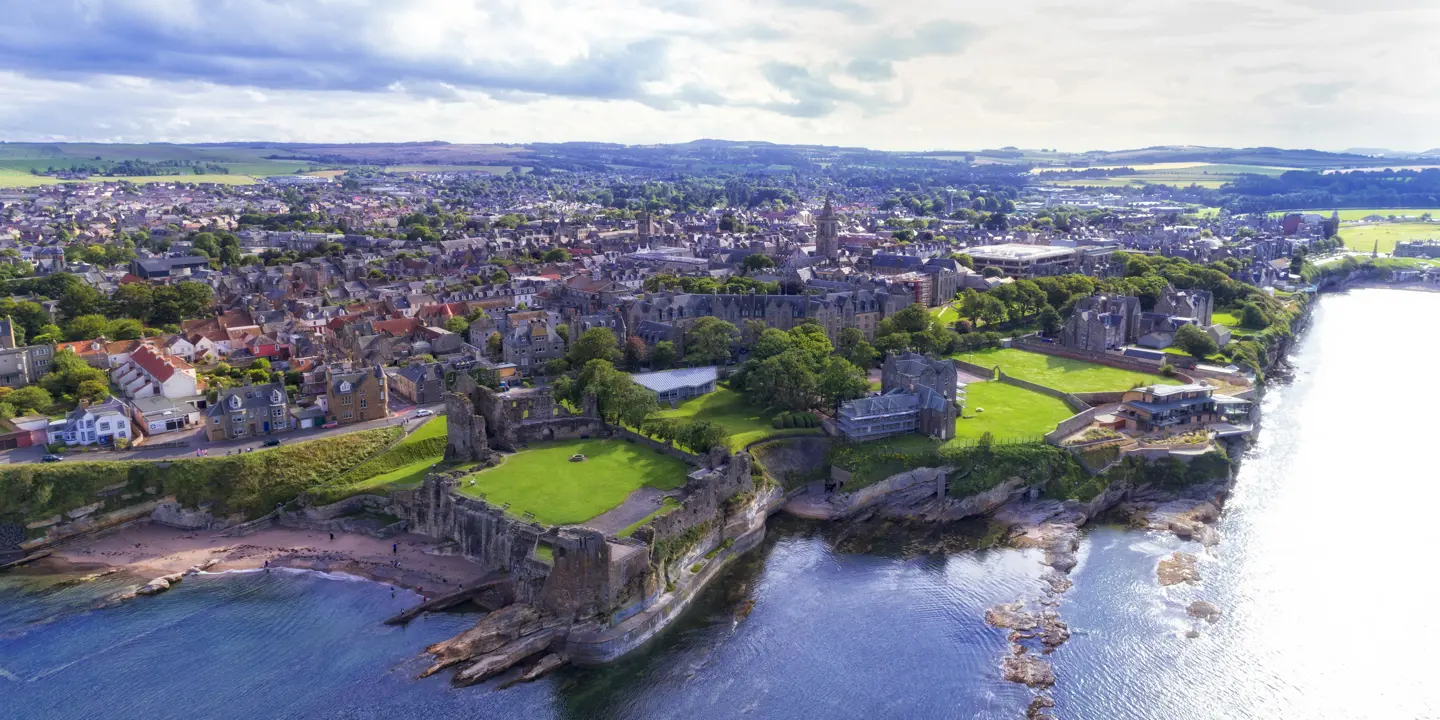 A panoramic view of a cityscape with a meandering river flowing through its midst.