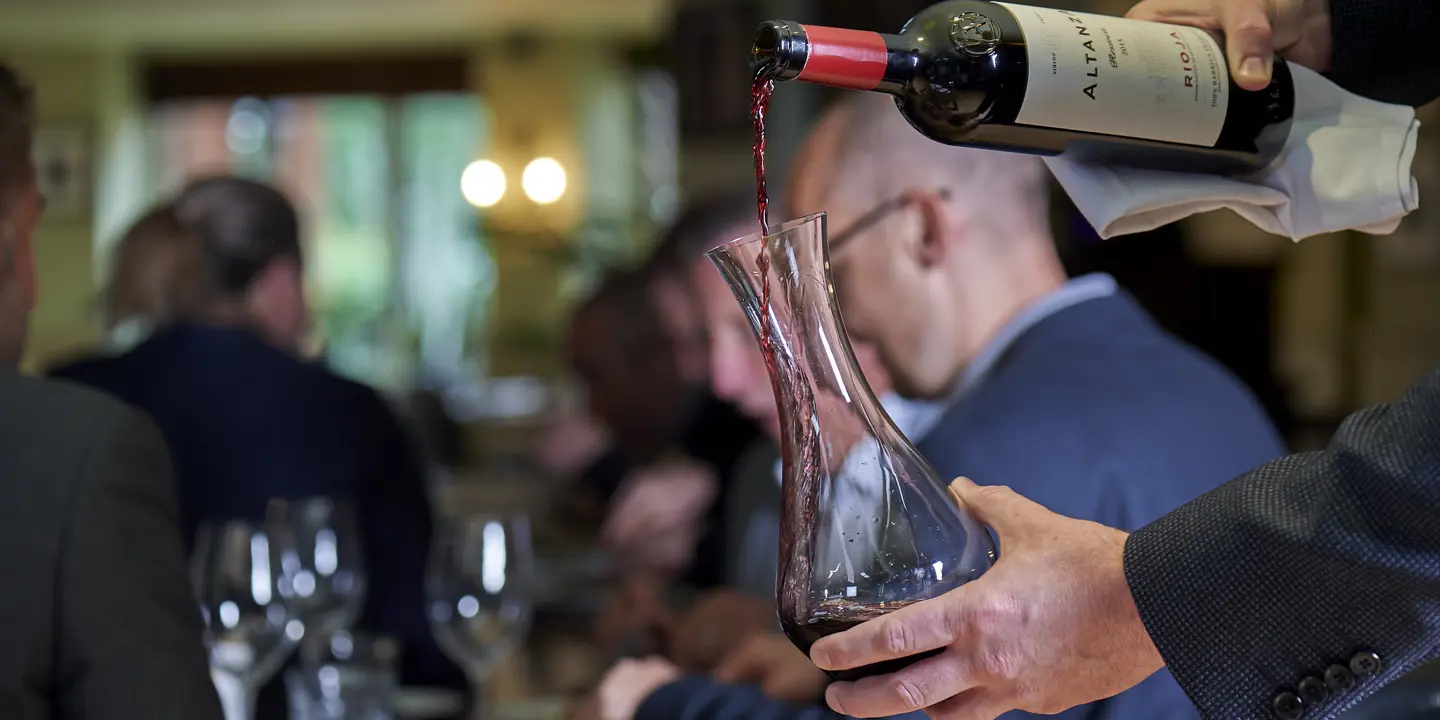 Man pouring red wine