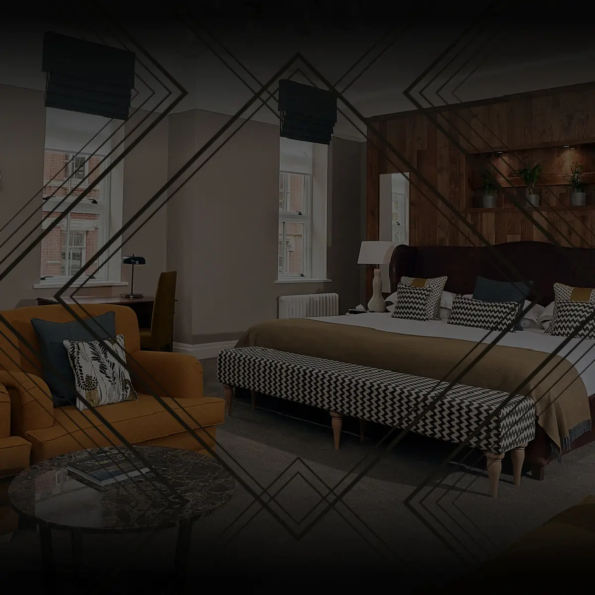 Luxurious bed in spacious room with comfy armchairs