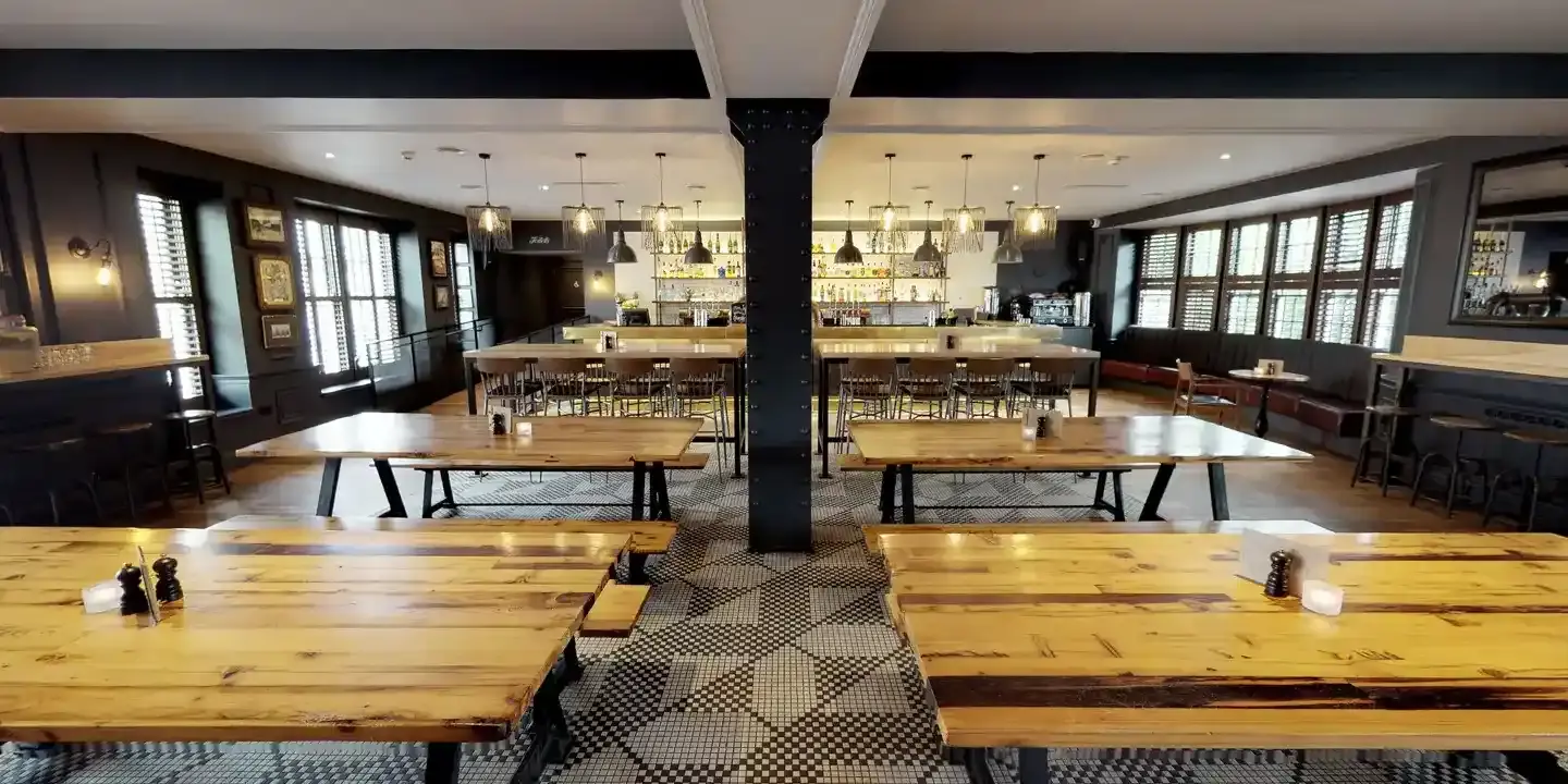 A restaurant featuring wooden tables and chairs.