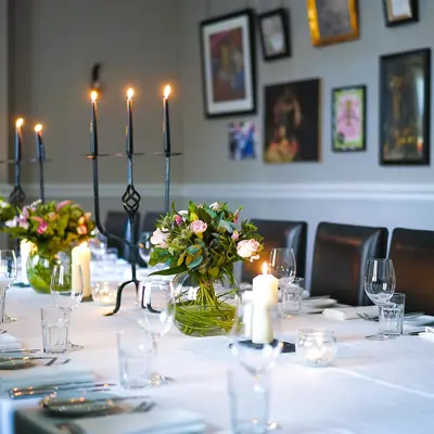 A beautifully adorned table with elegant candles and vibrant flowers.