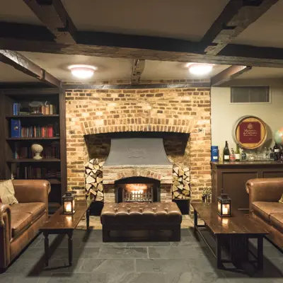 A cozy fireplace with 2 leather sofas facing each other