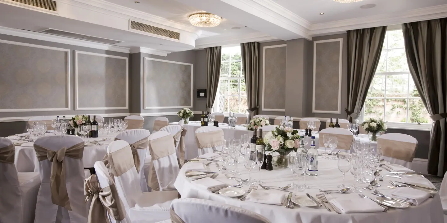 An elegantly arranged banquet room for a formal event.