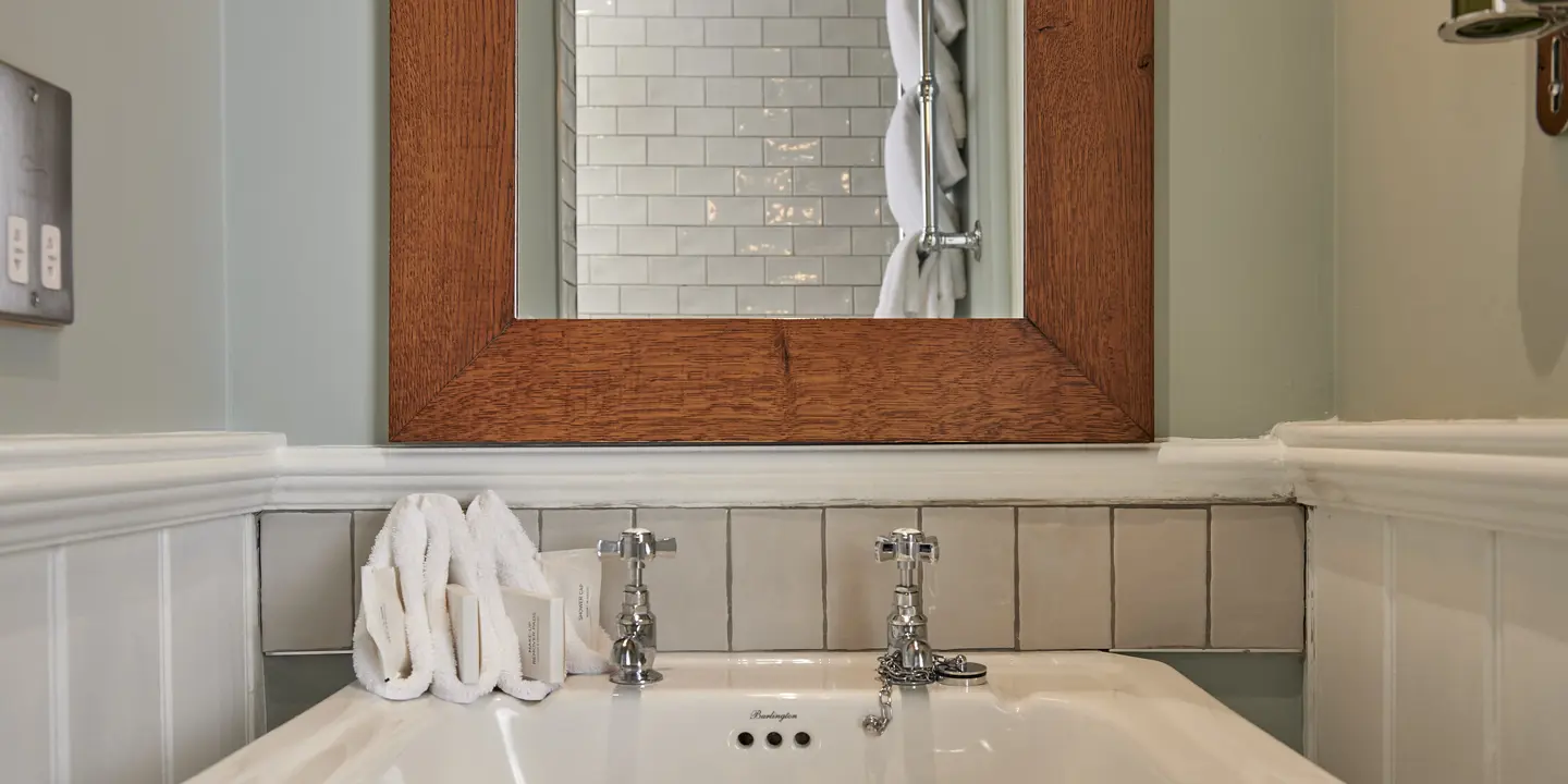 White sink positioned beneath a mirror in a bathroom.