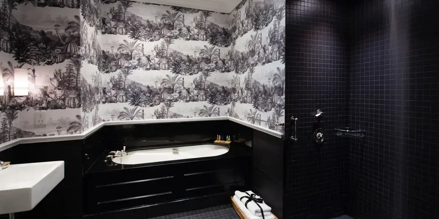 Black and white wallpaper in a bathroom.
