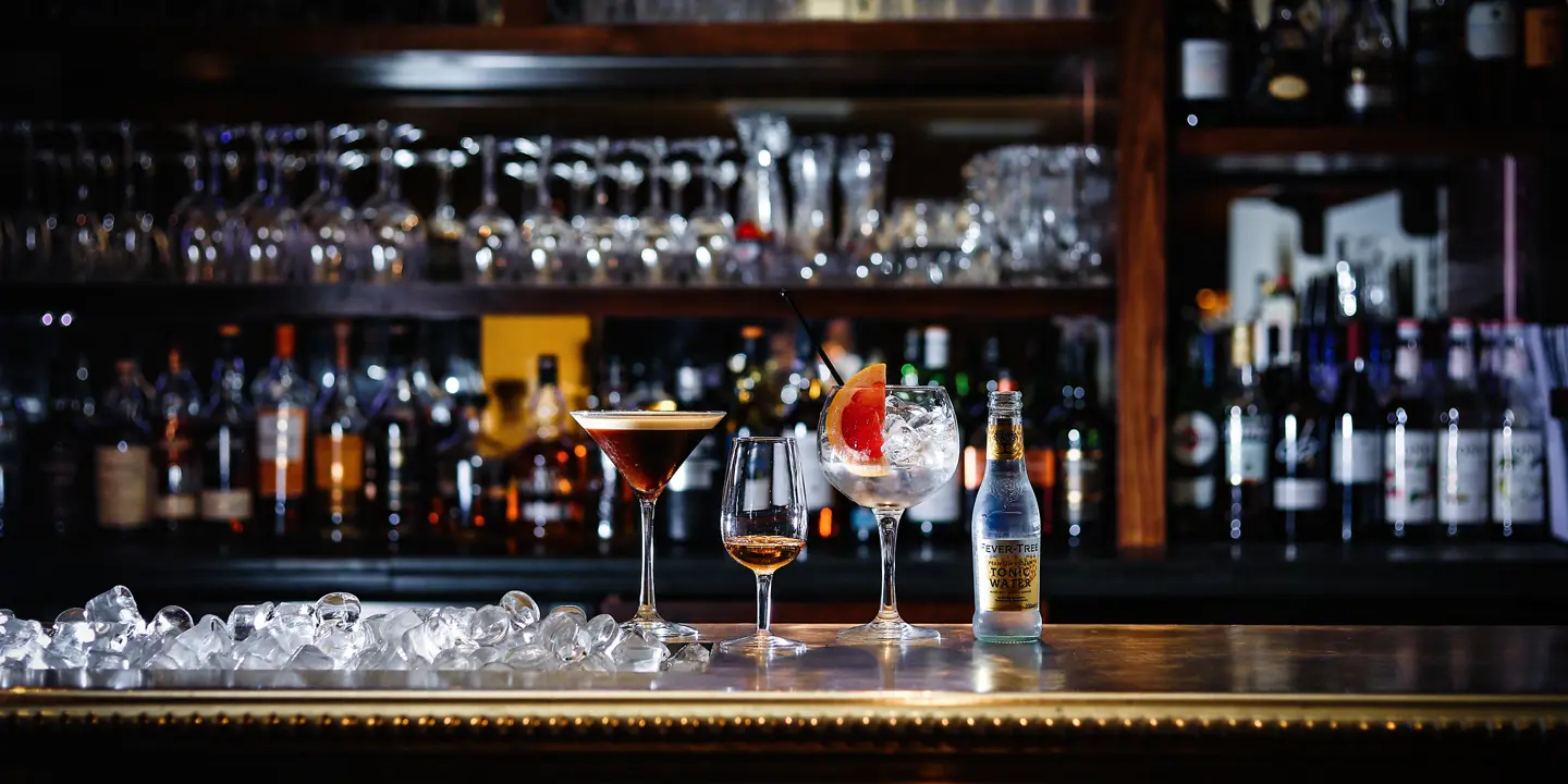 A well-stocked bar showcasing an array of bottles and glasses.