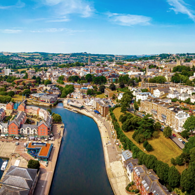 A panoramic view of a cityscape with a meandering river flowing through its midst.